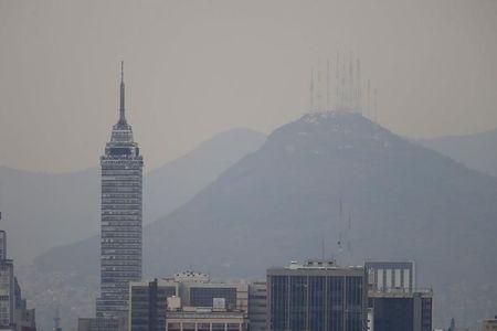 Buildings stand shrouded in smog in Mexico City